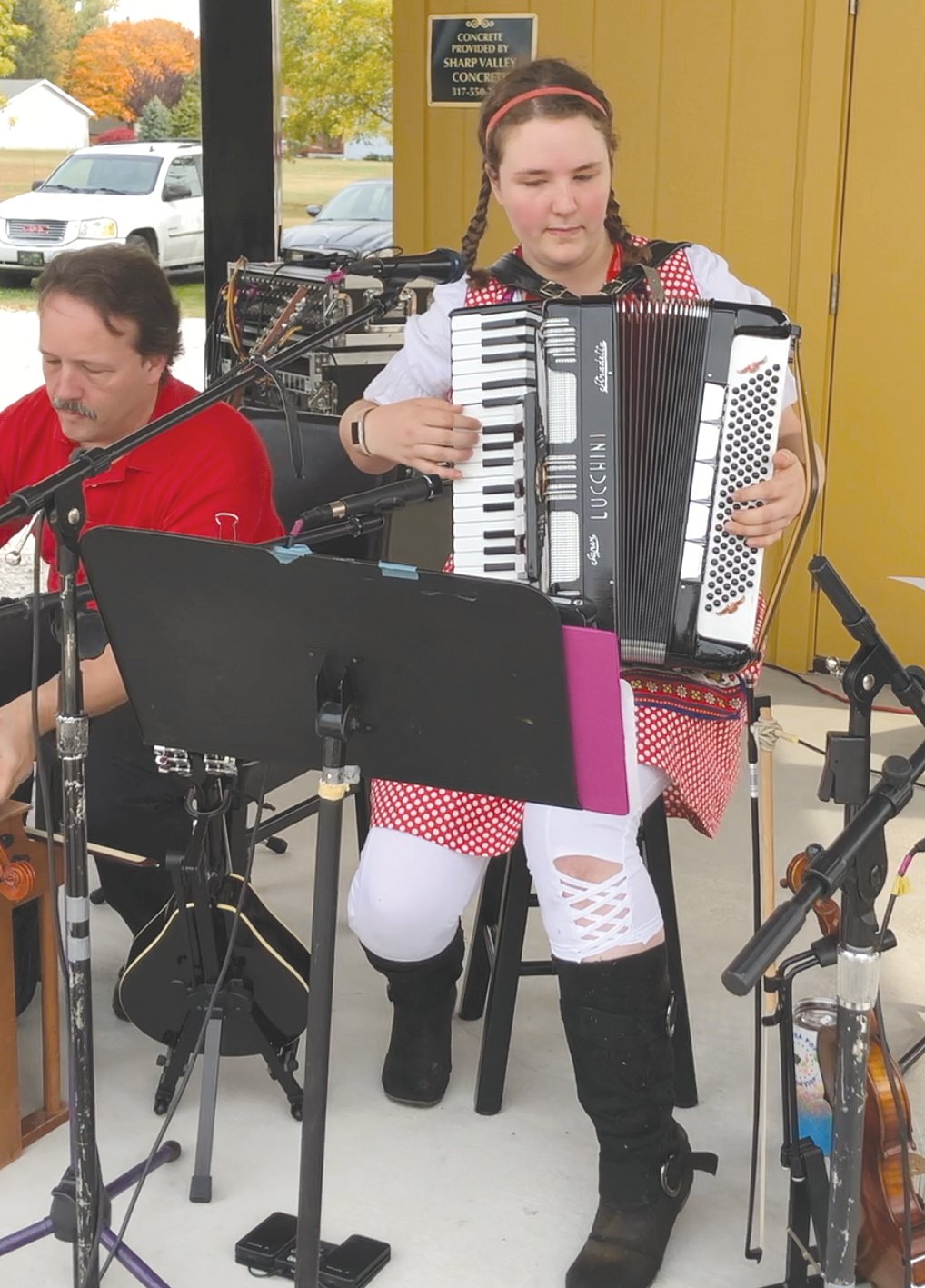 Josie Beach performs a song on the accordian on Satuday during Oktoberfest in Waynetown.